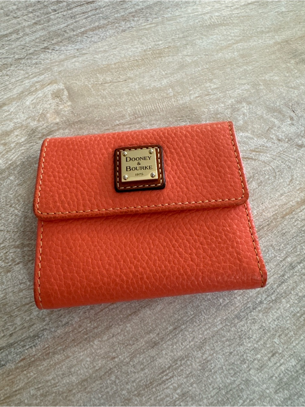 Dooney & Bourke Orange Pebble Leather Bifold Wallet with Logo Plaque